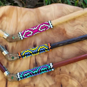 Three Shipibo Tepi applicators with colorful beaded designs